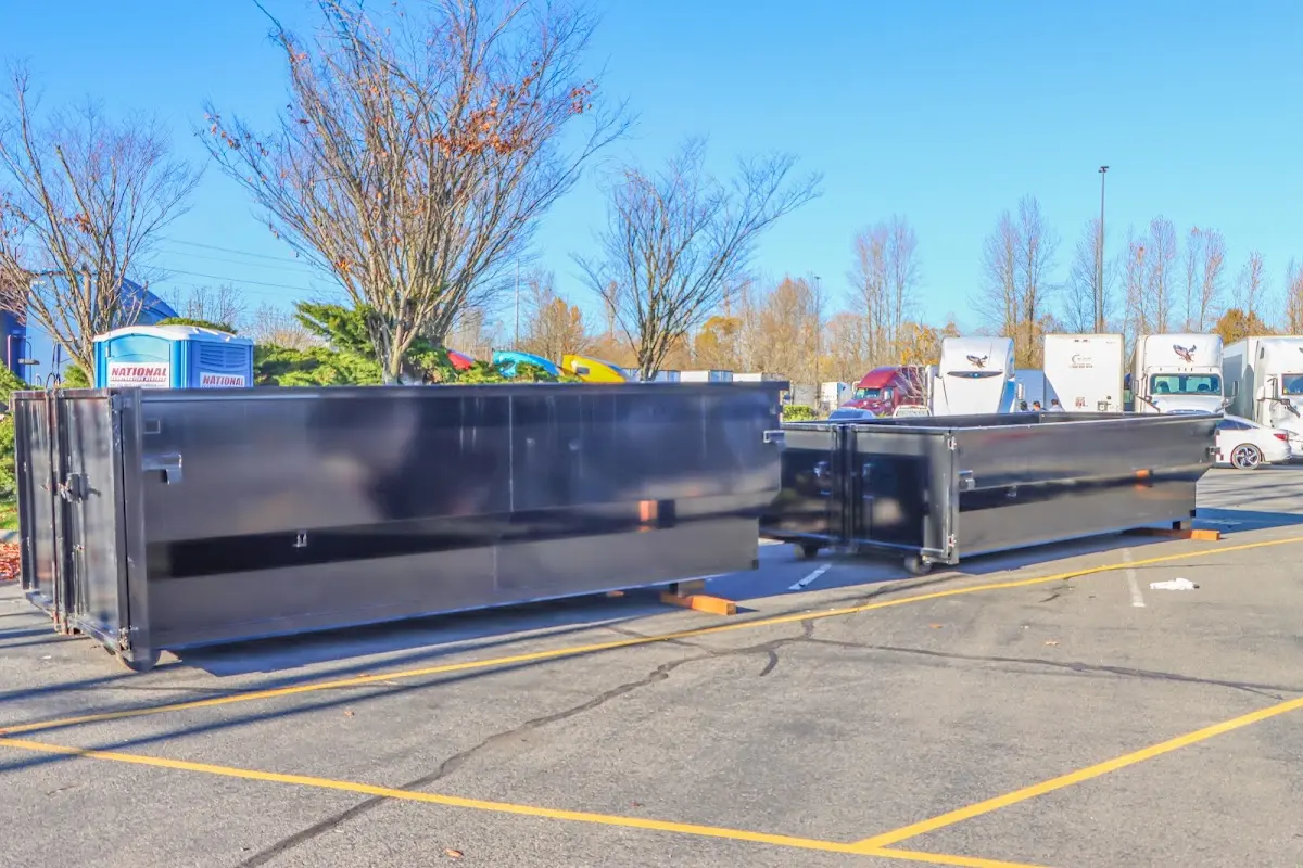 Professional dumpster rental service with roll-off container on residential driveway in Lahaina